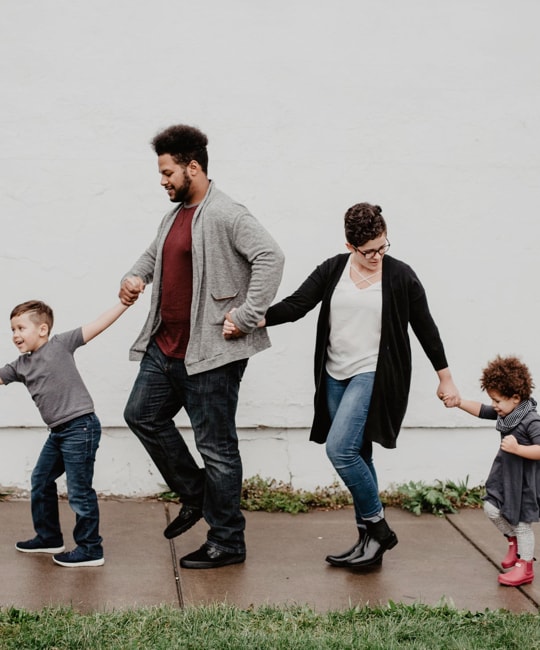 Smiling family walking inline