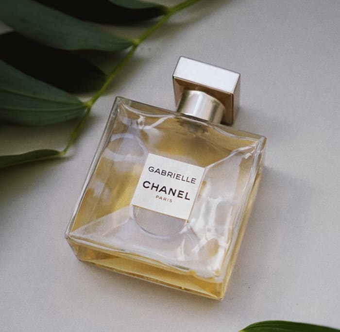 Gabrielle Essence Eau De Parfum bottle resting on a table